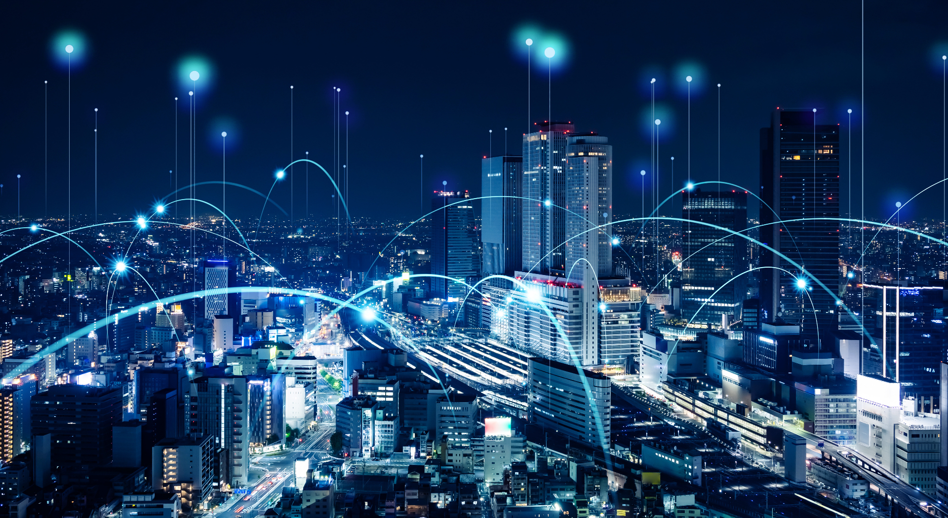 Connected city skyline at night with light nodes and arcs symbolising an innovation network.